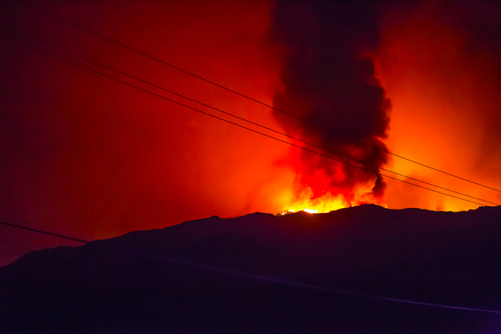 Wildfire burning with power lines